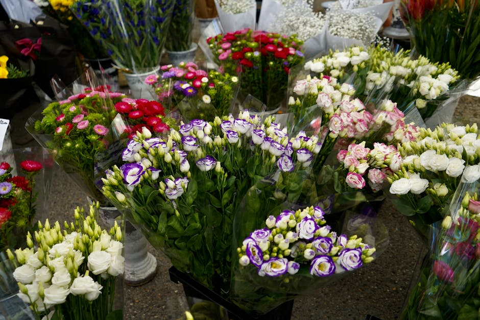 A variety of fresh floral bouquets arranged on a display table at floristwanstead.co.uk, featuring an assortment of flowers in vibrant colors such as white, pink, purple, red, and green. The bouquets